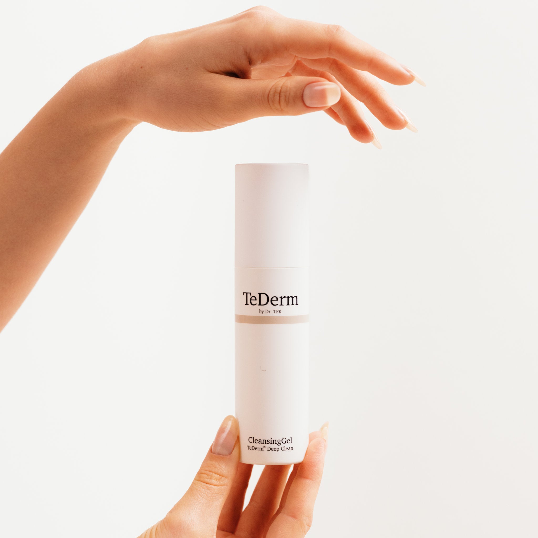 Hands holding TeDerm CleansingGel – daily facial cleansing